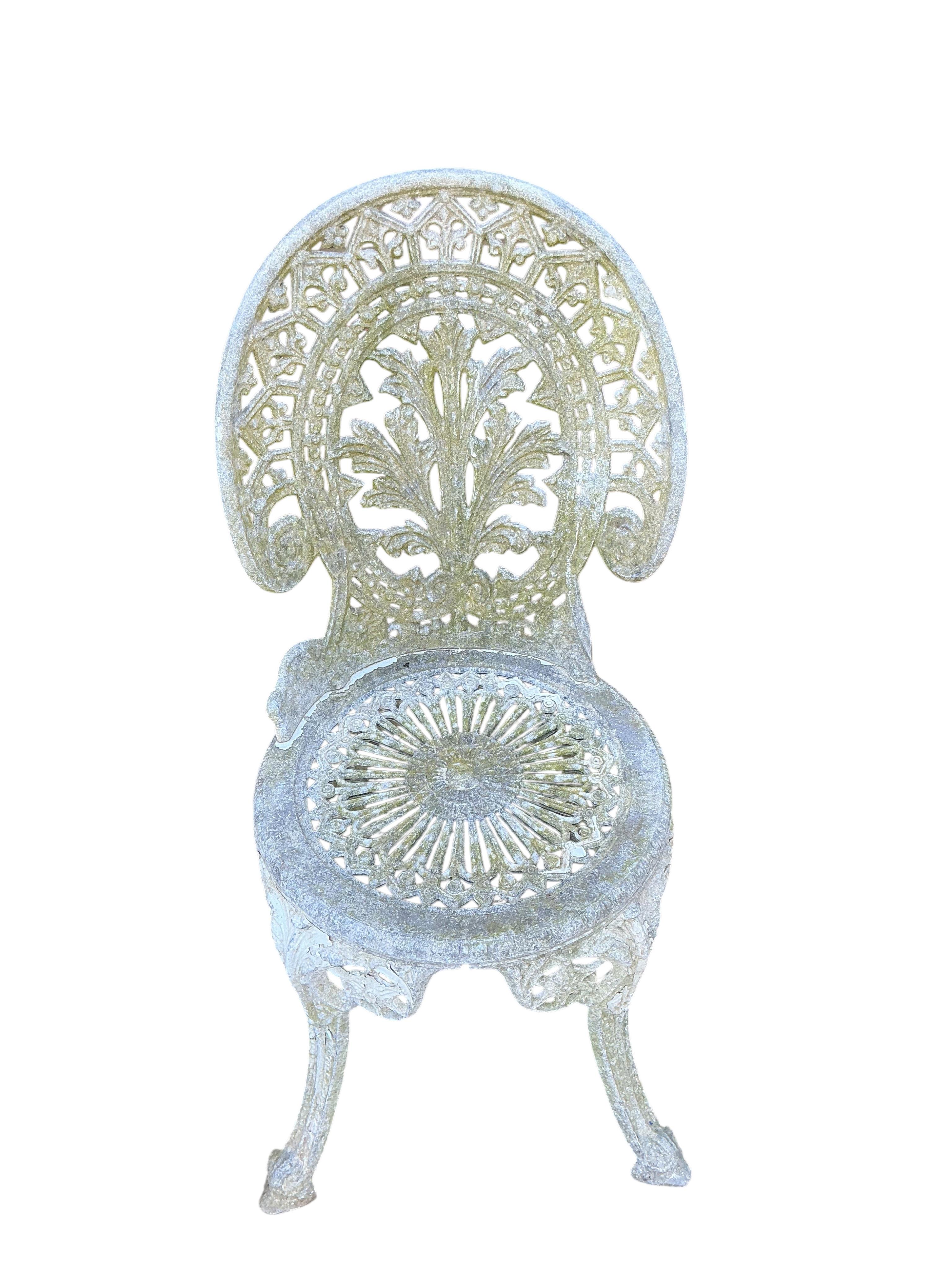 A Victorian style circular painted aluminium garden table, diameter 66cm, height 71cm and two similar garden chairs